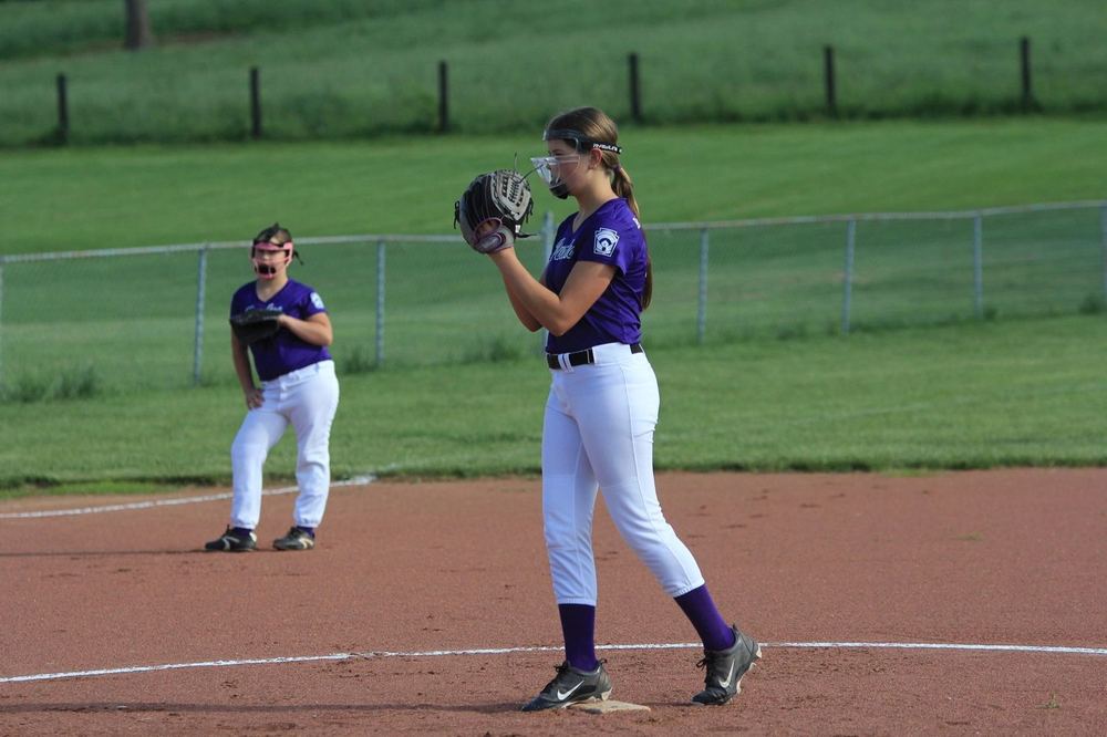 Two older Winchester Little League softball players in the infield between plays.