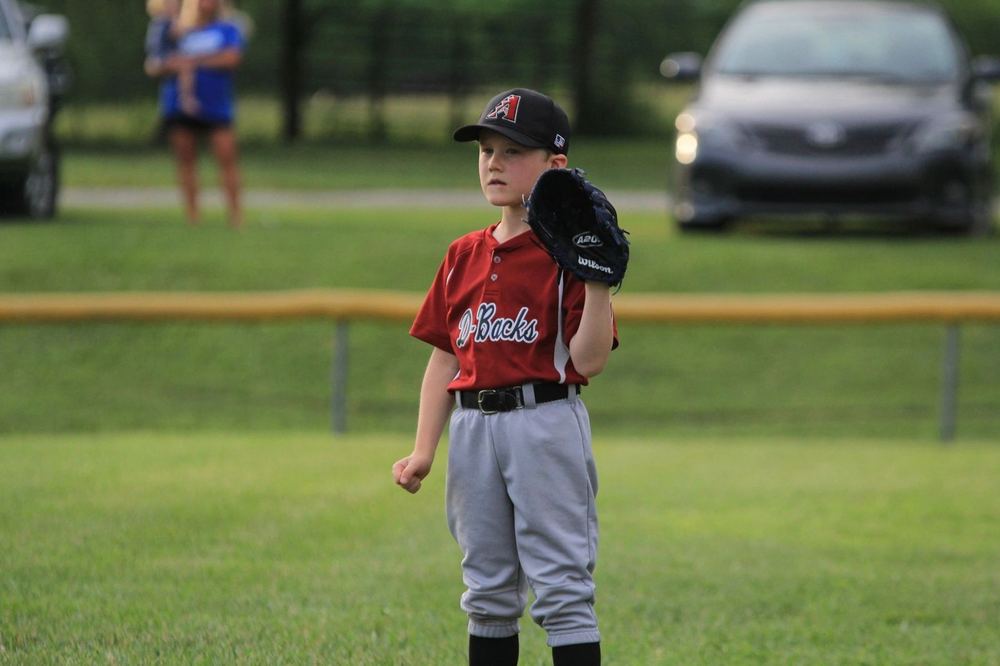 A young Winchester Little League baseball player at bat during a game.