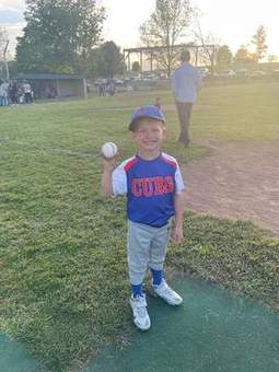 A Winchester Little League player holding a ball in 2023.