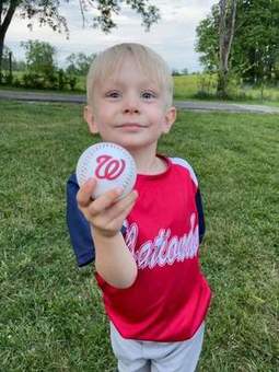 A Winchester Little League softball player at bat during a 2023 game.