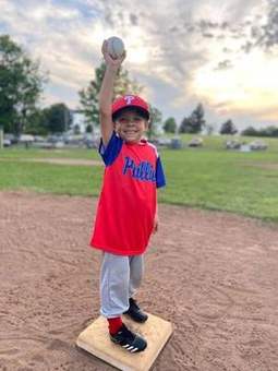 A Winchester Little League player throwing the ball during warmups in 2023.